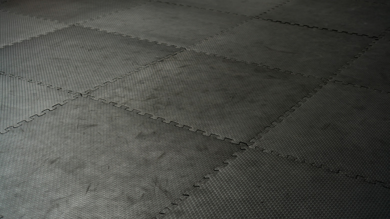 Black interlocking floor tiles