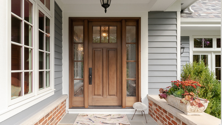 A large house has a brown wood door