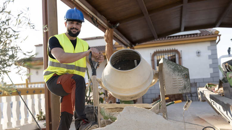 Worker using concrete mixer