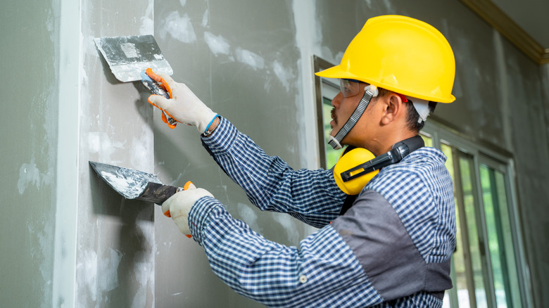 Man installing drywall 