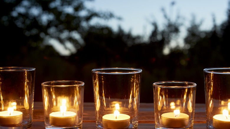 Tea light holders lined up on table