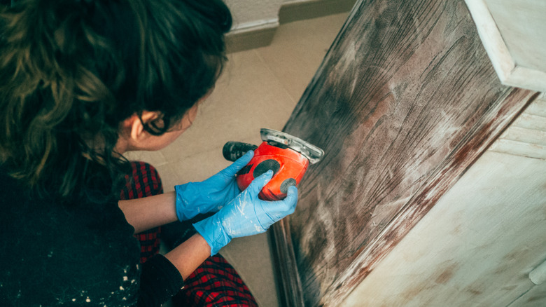 waman using a sander