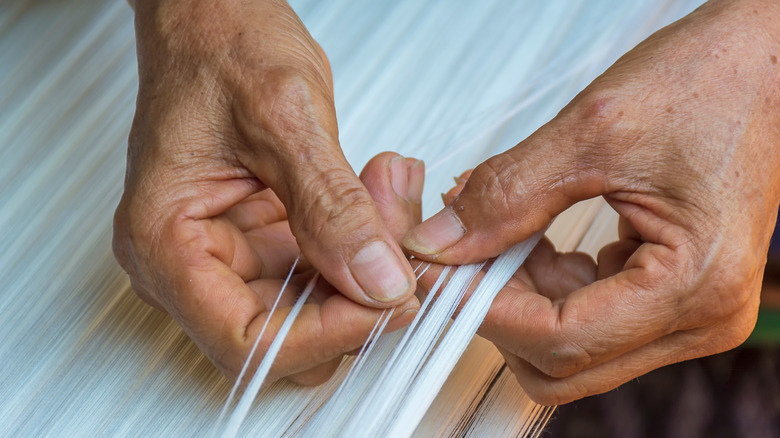 woman counting threads for weaving