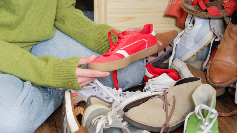 A woman is organizing shoes