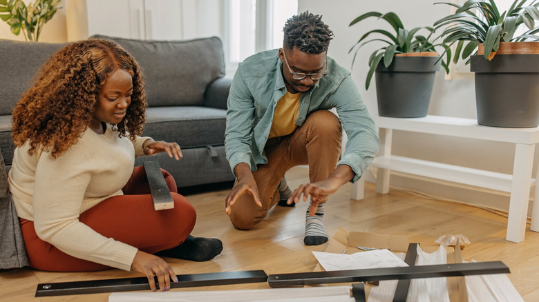 couple assembling furniture