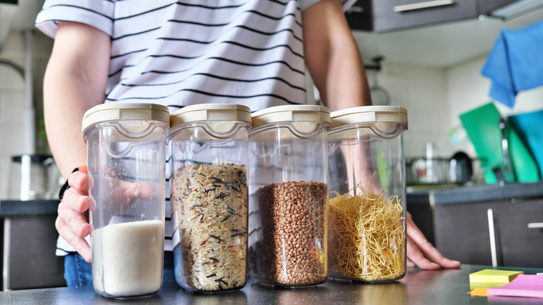 Woman organizing airtight containers of dry foods