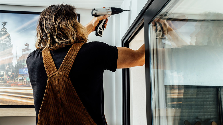 man drilling into wall