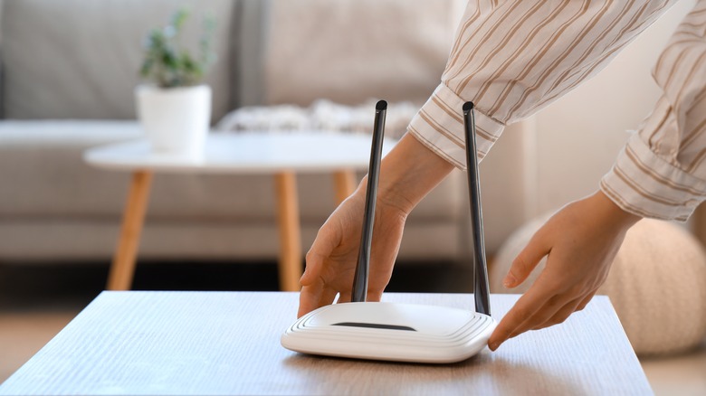 Woman setting up her Wi-Fi router.