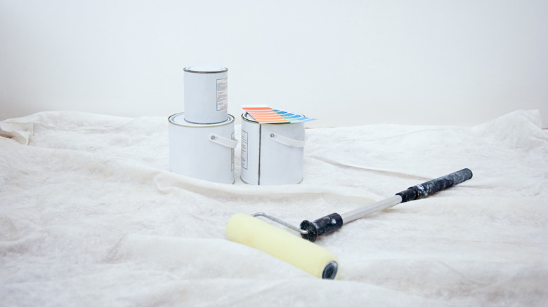 paint roller and paint cans for ceiling paint job