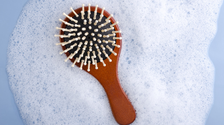 Hairbrush sits in soapy basin