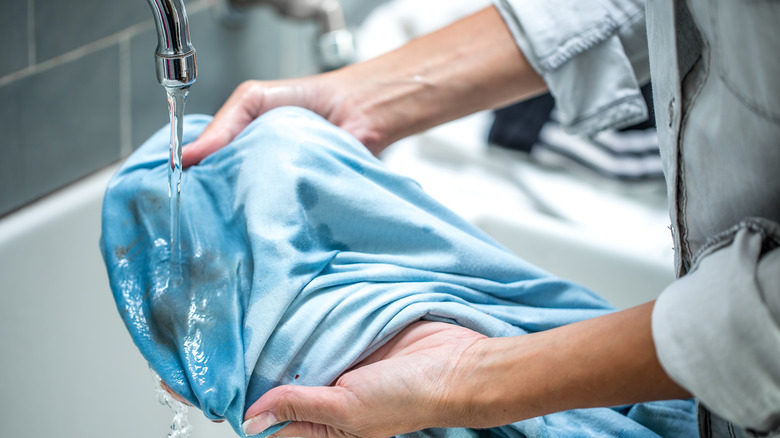 Hand cleaning stained clothes