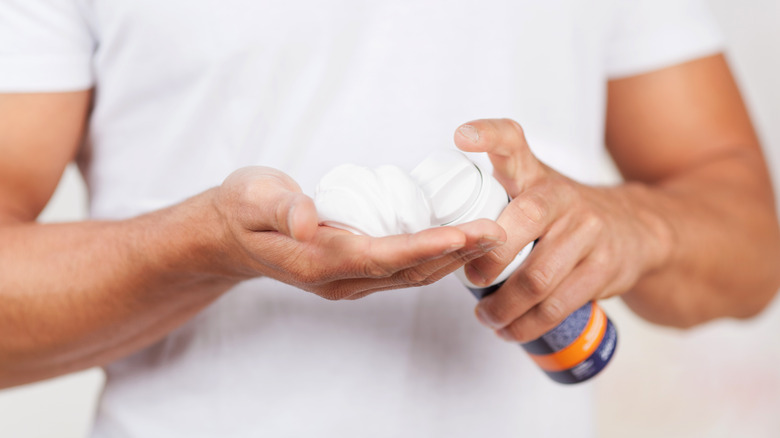 Person holding shaving cream