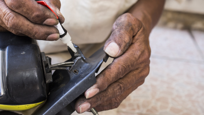 Man repairing with super glue