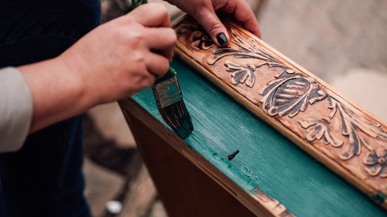 person painting drawer