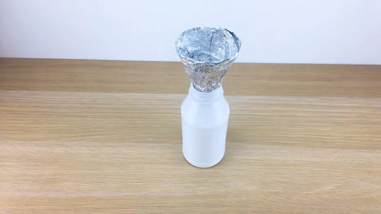 Foil funnel sitting in a bottle