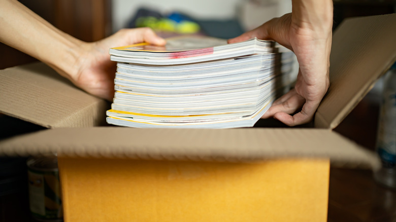 Loading stacks of magazines into boxes