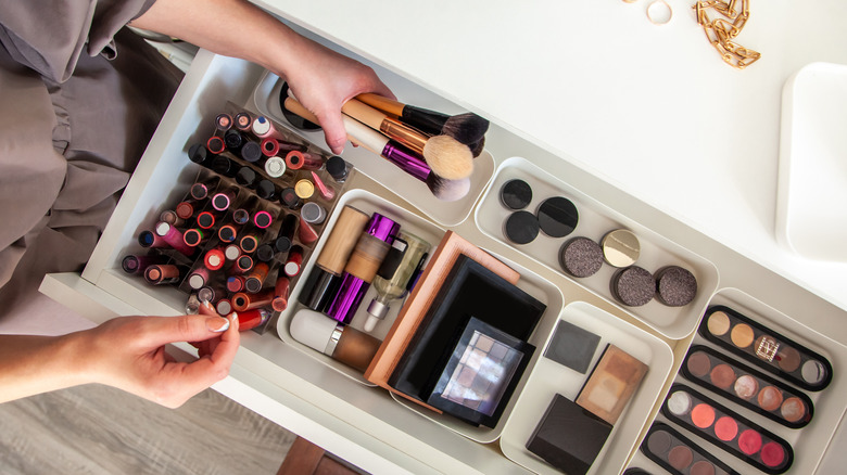 Woman organizing her cosmetic containers