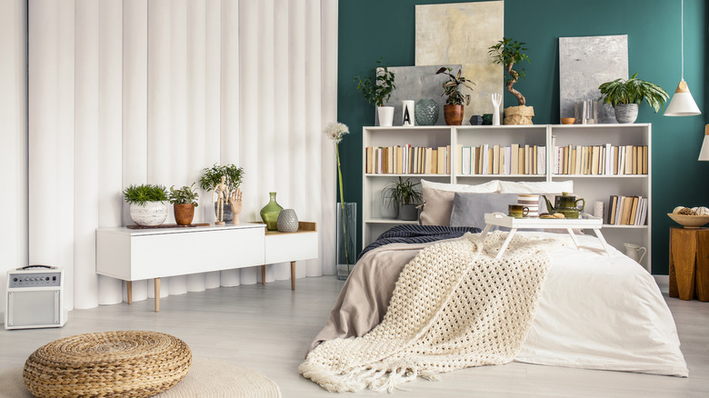 room with bookcase as headboard