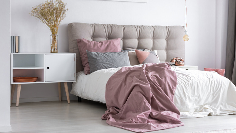 bedroom with tufted headboard