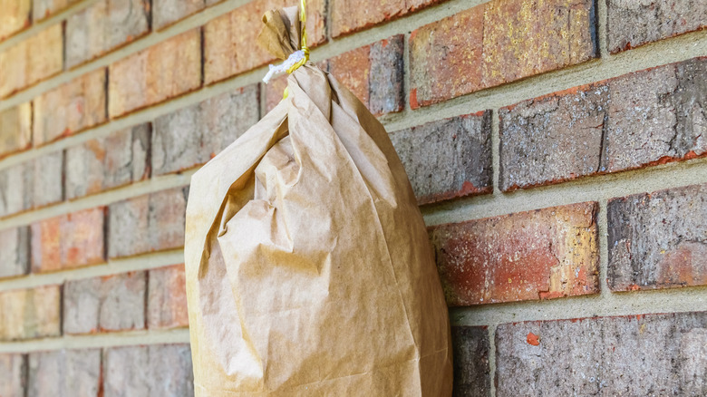 brown bag hanging on brick wall