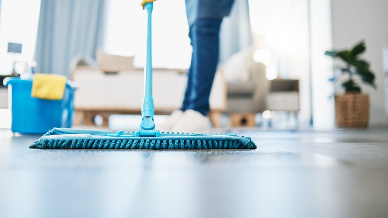 Mopping floor in living room