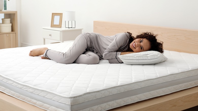 Young woman on comfortable mattress