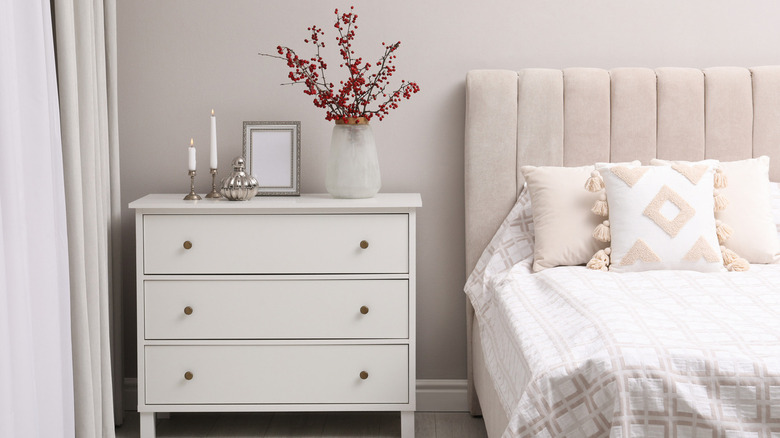 White dresser with brass knobs