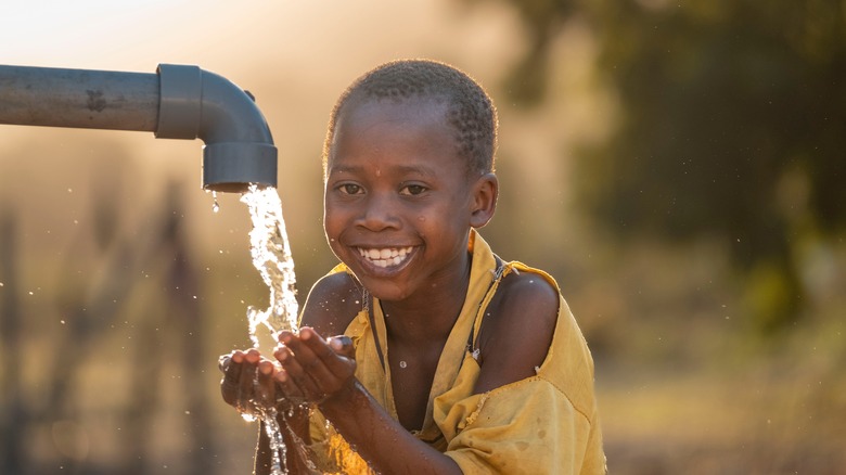 Child smiling while catching water