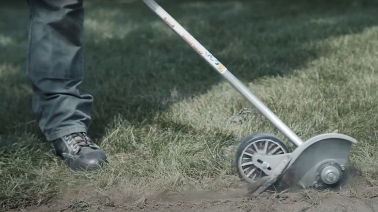 person using an Echo edger attachment