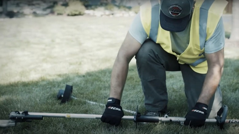 man adding attachment to Echo weed eater