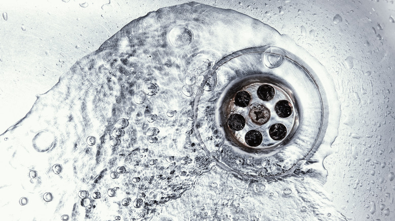 swirling water around silver drain