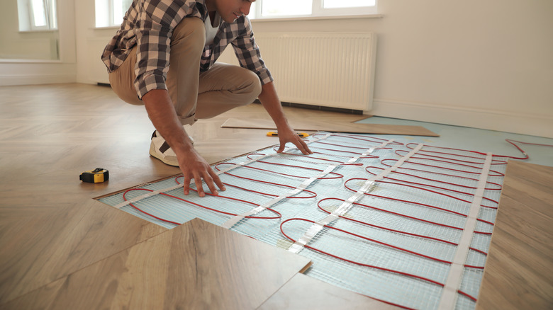 man installing radiant heat floors