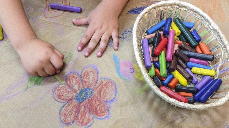Child's hand drawing flower