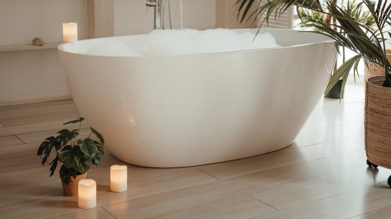 flameless candles next to bathtub