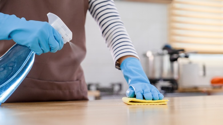 Person cleaning with rubbing alcohol