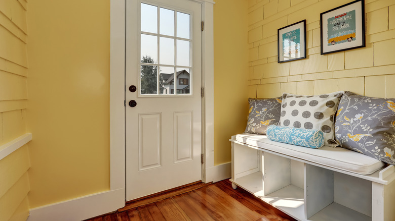 pillows on a bench in an entryway