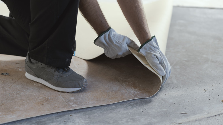 Contractor removing linoleum flooring