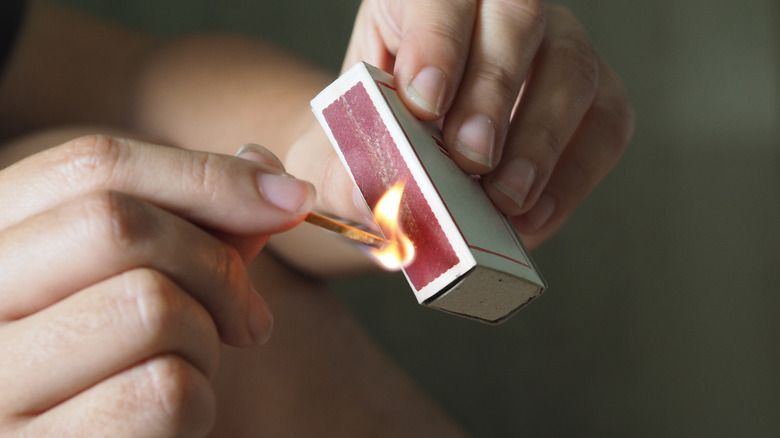 Person striking a match