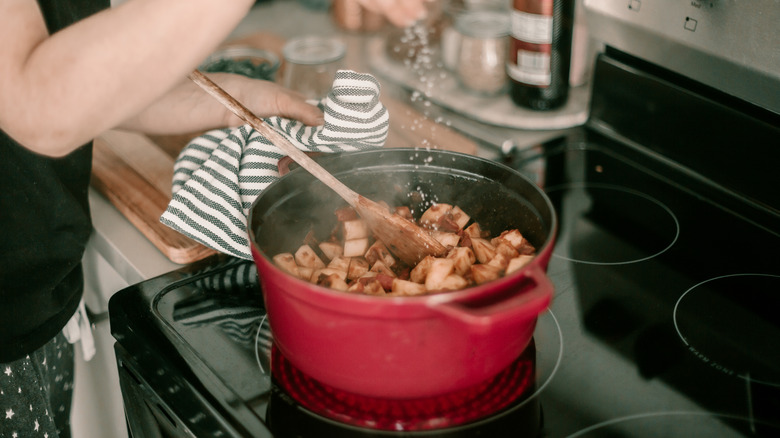 woman cooking in dutch oven