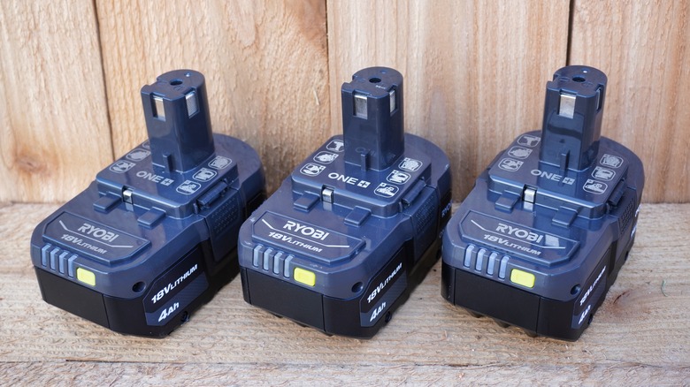 three Ryobi cordless power tool batteries