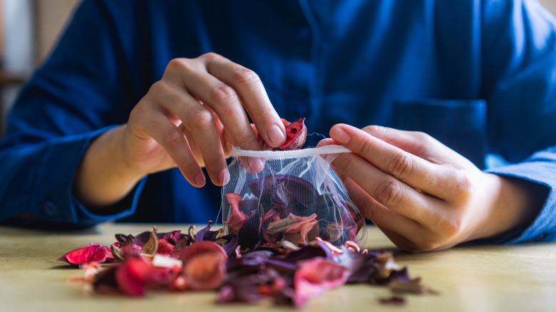 woman putting potpourri in bag