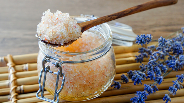 wooden spoon scooping jar of Epsom salt