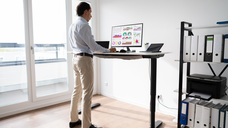 man working at standing desk