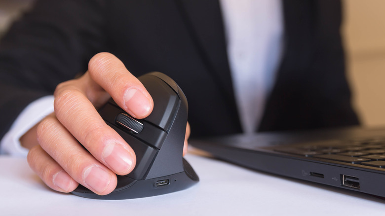 person holding an ergonomic mouse