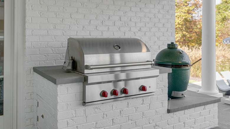 An outdoor kitchen with a grill