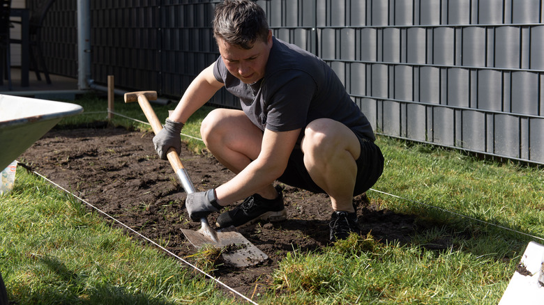 Person removing turf for border