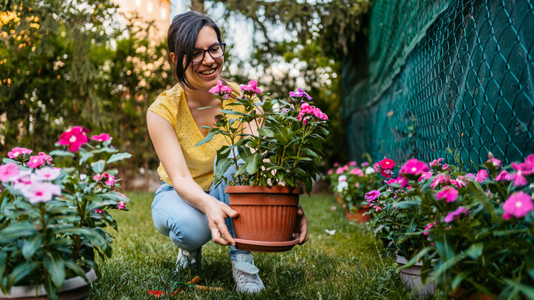 woman with pot of flowers