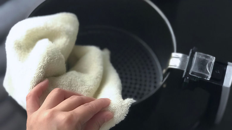 Person cleaning their air fryer basket