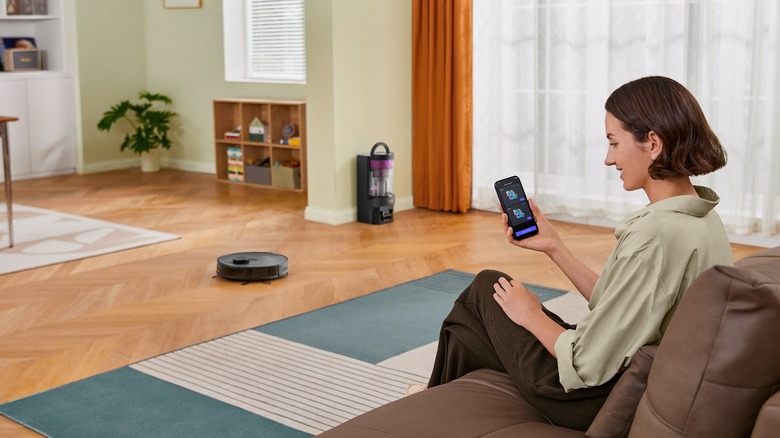 Woman reading phone on couch