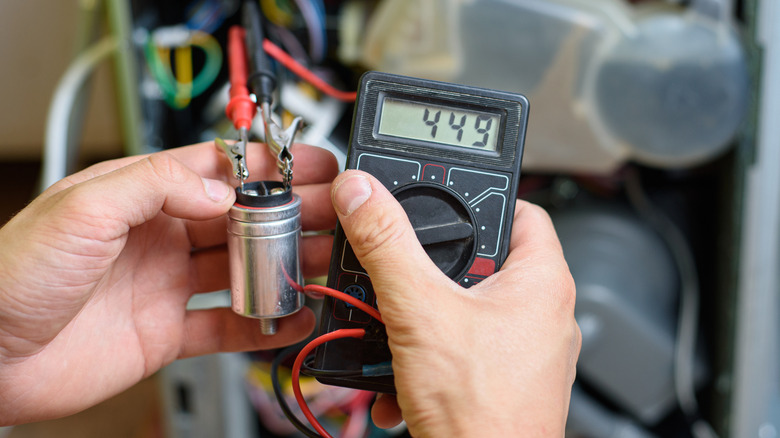 Using a multimeter to test a dishwasher capacitor